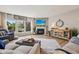 Bright living room with fireplace, large windows, and views of the lake at 19281 Scofield Ridge Blvd, Westfield, IN 46074