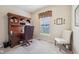 Well-lit home office with a classic wooden desk and chair, complemented by a neutral color scheme and natural light at 19281 Scofield Ridge Blvd, Westfield, IN 46074