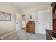 Inviting room with a rustic wood desk, neutral walls, and a carpet floor, complemented by an open doorway and closet at 19281 Scofield Ridge Blvd, Westfield, IN 46074