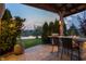 Backyard patio featuring an outdoor kitchen and bar, with seating overlooking the yard and lake at 19281 Scofield Ridge Blvd, Westfield, IN 46074