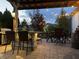Cozy outdoor kitchen with a grill, bar, and seating area, perfect for entertaining guests at 19281 Scofield Ridge Blvd, Westfield, IN 46074