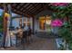 Covered patio with outdoor kitchen features a bar, seating, and access to the home's interior at 19281 Scofield Ridge Blvd, Westfield, IN 46074