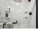 Modern shower with dark trim, neutral tile and shelving at 19281 Scofield Ridge Blvd, Westfield, IN 46074
