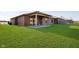 Expansive backyard featuring lush lawn, a concrete patio, and a well-maintained brick exterior at 202 Asbury Dr, Anderson, IN 46013