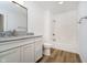 Bathroom features a modern vanity with granite countertop and a shower-tub combination at 202 Asbury Dr, Anderson, IN 46013