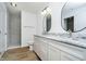 Bright bathroom featuring double sinks with granite countertops and a glass enclosed shower at 202 Asbury Dr, Anderson, IN 46013