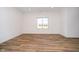 Bright bedroom featuring hardwood floors and a large window at 202 Asbury Dr, Anderson, IN 46013