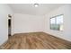 Cozy bedroom featuring hardwood floors and a large window at 202 Asbury Dr, Anderson, IN 46013