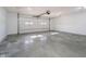 Spacious garage with concrete floors, an automatic door with windows, and ample room for vehicles at 202 Asbury Dr, Anderson, IN 46013