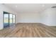 Large living area with sliding glass doors and beautiful hard surface floors at 202 Asbury Dr, Anderson, IN 46013