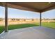 Covered patio overlooking well-maintained landscaping with mature trees and a beautiful lawn at 202 Asbury Dr, Anderson, IN 46013