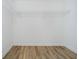 Bright walk-in closet with a clean white interior, wood-look floors, and wire shelving for storage at 202 Asbury Dr, Anderson, IN 46013