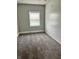 Cozy bedroom features soft gray carpet, natural light from a window, and beadboard accent wall at 2244 Lafayette St, Anderson, IN 46012