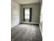Inviting bedroom with soft gray carpet, beadboard wall, and natural light at 2244 Lafayette St, Anderson, IN 46012
