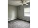 Bright bedroom boasts soft gray carpet, ceiling fan and 'you are strong' wall decor at 2244 Lafayette St, Anderson, IN 46012