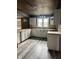 Charming kitchen featuring white cabinets, wooden countertop, and a modern stainless steel sink at 2244 Lafayette St, Anderson, IN 46012