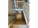 Carpeted staircase leads to the lower level, featuring white railing and neutral paint at 2244 Lafayette St, Anderson, IN 46012