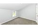 Cozy bedroom with gray walls, neutral carpet, and a bright window at 2413 Fowler St, Anderson, IN 46012