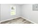 Cozy bedroom featuring a large window, fresh paint, and new vinyl plank flooring at 2413 Fowler St, Anderson, IN 46012