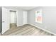 Bright bedroom featuring a closet, fresh paint, and new vinyl plank flooring at 2413 Fowler St, Anderson, IN 46012