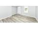 A light and open home entryway with attractive wood-look floors, and a white front door and window at 2413 Fowler St, Anderson, IN 46012