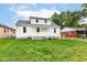 Charming two-story home features a welcoming porch, landscaped yard, and bright white siding at 2413 Fowler St, Anderson, IN 46012