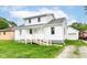 Attractive home featuring bright white siding, a covered front porch, and a well-manicured lawn at 2413 Fowler St, Anderson, IN 46012