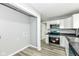 Bright kitchen space with new stainless steel appliances, white cabinets, and new flooring at 2413 Fowler St, Anderson, IN 46012