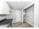 Efficient kitchen space featuring a door to the backyard, white cabinets, and a sleek countertop at 2413 Fowler St, Anderson, IN 46012