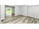 The living room features sleek wood-look flooring, neutral paint, and access to the backyard through sliding glass doors at 2413 Fowler St, Anderson, IN 46012