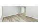 This living room features sleek wood-look flooring, neutral paint, and bright natural light at 2413 Fowler St, Anderson, IN 46012