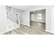 Bright and airy living room area showcasing new vinyl plank flooring and fresh paint at 2413 Fowler St, Anderson, IN 46012
