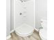Corner shower unit featuring white subway tile, corner shelves and vinyl flooring at 2413 Fowler St, Anderson, IN 46012