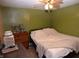 View of a bedroom featuring a bed, dresser, and soft lighting at 2616 Jackson St, Anderson, IN 46016