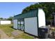 Well-maintained storage shed with a green roof and decorative trim at 2616 Jackson St, Anderson, IN 46016