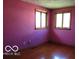 Bedroom features hardwood floors, and two windows for natural light at 311 Fall Creek Dr, Anderson, IN 46013