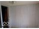 Room featuring neutral color wall panels, light fixture, and a door at 311 Fall Creek Dr, Anderson, IN 46013