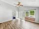 Inviting living room featuring wood-look floors, a ceiling fan, and ample natural light at 3251 Mars Hill St, Indianapolis, IN 46221