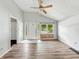 Bright living room featuring wood-look floors, front door with glass panes, and natural light at 3251 Mars Hill St, Indianapolis, IN 46221