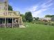 Expansive backyard with a multi-level deck, hot tub, and stunning water views; perfect for outdoor living at 3287 Buckmoor Pkwy, Greenwood, IN 46143