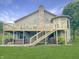Expansive backyard featuring a two-story deck with stairs, a spa, and well-maintained green lawn at 3287 Buckmoor Pkwy, Greenwood, IN 46143