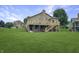 Beautiful backyard featuring a large deck with stairs and a manicured lawn at 3287 Buckmoor Pkwy, Greenwood, IN 46143