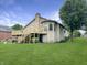 Home with large deck, stairway, chimney, with landscaped backyard with grass and a leafy tree at 3287 Buckmoor Pkwy, Greenwood, IN 46143