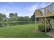 Gorgeous backyard featuring a tranquil pond, lush lawn and deck with stairway at 3287 Buckmoor Pkwy, Greenwood, IN 46143