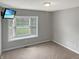 Bedroom with carpet, television, and a large bay window, providing natural light at 3287 Buckmoor Pkwy, Greenwood, IN 46143