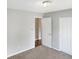 A bedroom is bathed in natural light, carpeted, and features a closet and doorway to another room at 3287 Buckmoor Pkwy, Greenwood, IN 46143