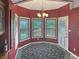 This breakfast nook features a beautiful chandelier and lots of natural light from the surrounding windows at 3287 Buckmoor Pkwy, Greenwood, IN 46143