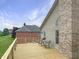 Wooden deck with seating provides a perfect spot to enjoy the scenic views of the lush green lawn and surroundings at 3287 Buckmoor Pkwy, Greenwood, IN 46143