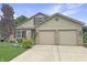 Well-maintained two-story home featuring a two-car garage, brick accents, and neat landscaping at 3287 Buckmoor Pkwy, Greenwood, IN 46143