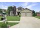 Charming two-story home with a well-manicured lawn and a two-car garage and neutral siding at 3287 Buckmoor Pkwy, Greenwood, IN 46143